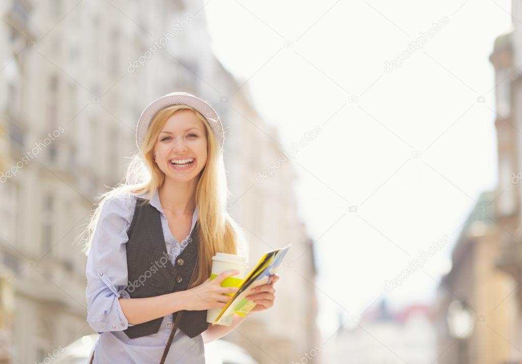 Happy woman tourist with map