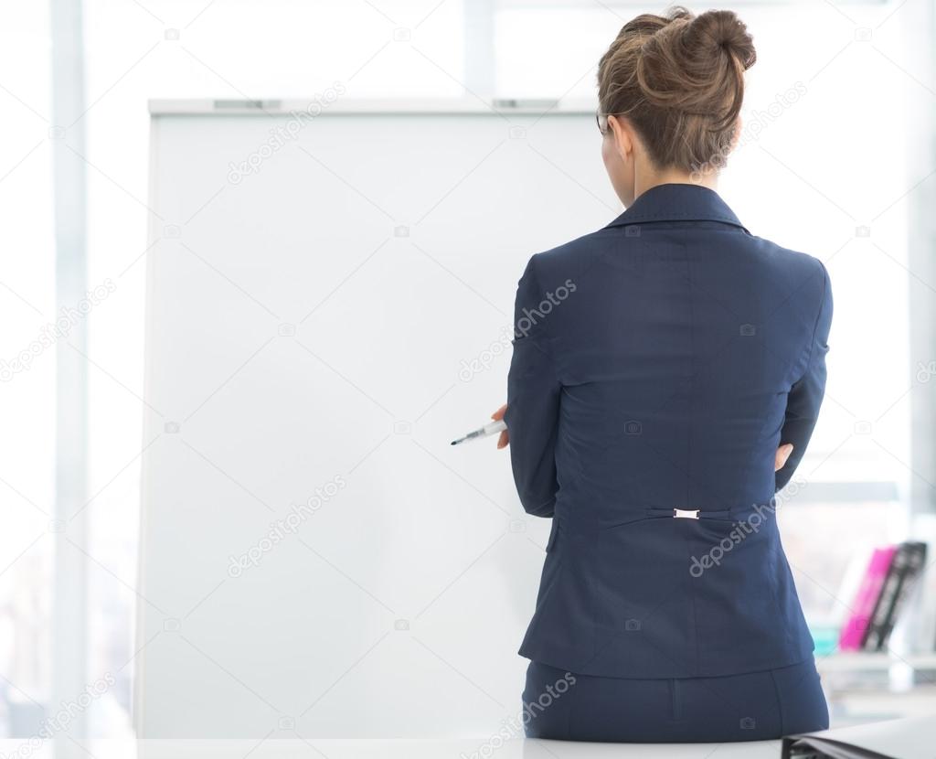 Business woman standing near flipchart