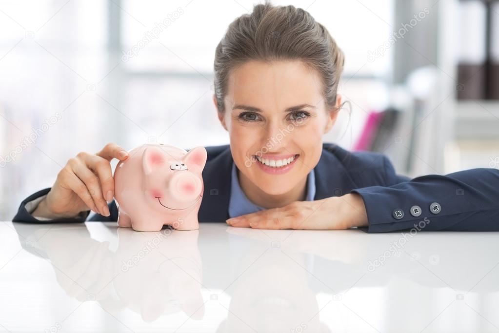 Business woman with piggy bank
