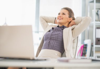 Relaxed business woman in office clipart