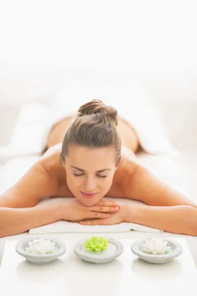 Young woman laying on massage table — Stock Photo, Image