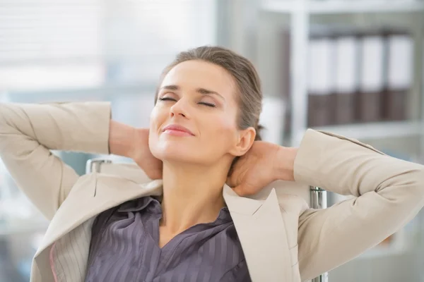 Relaxed business woman in office — Stock Photo, Image
