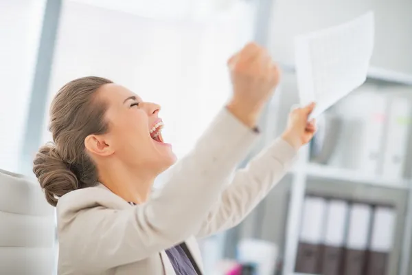 Business woman in office rejoicing success — Stok fotoğraf