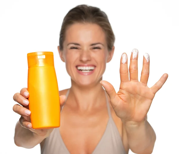 Woman showing sun screen creme — Stock Photo, Image