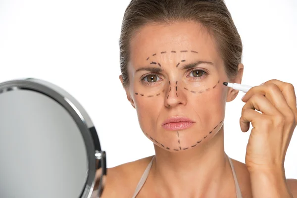 Woman applying plastic surgery marks — Stock Photo, Image