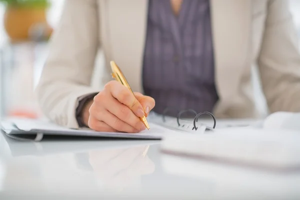 Business woman writing in document — Stock Photo, Image
