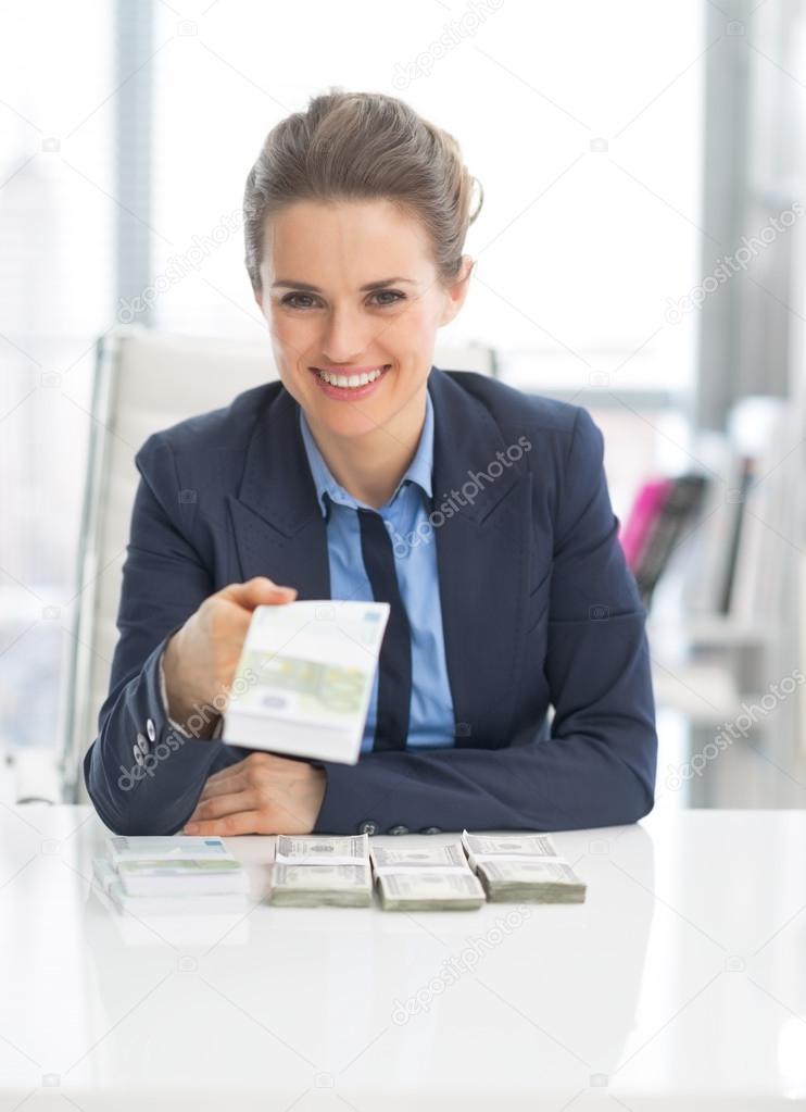 Business woman giving money packs