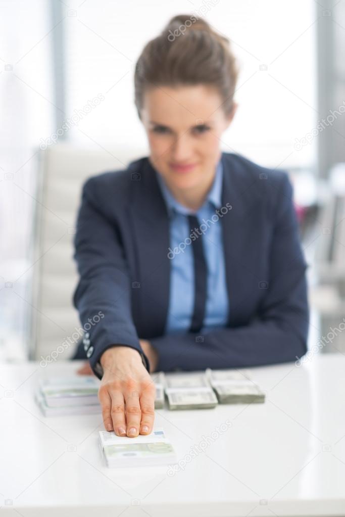 Business woman giving money pack