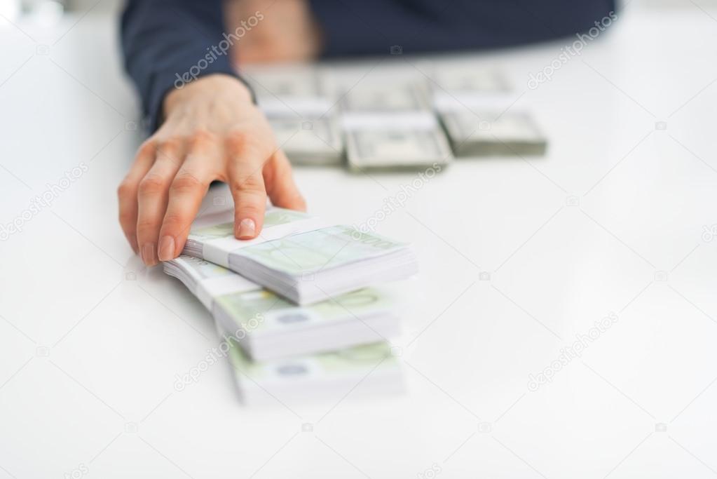 Business woman giving money packs