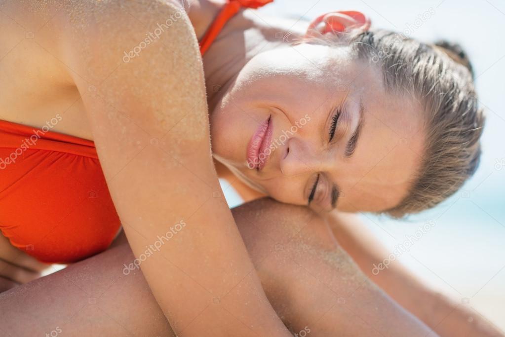 Happy young woman relaxing on beach