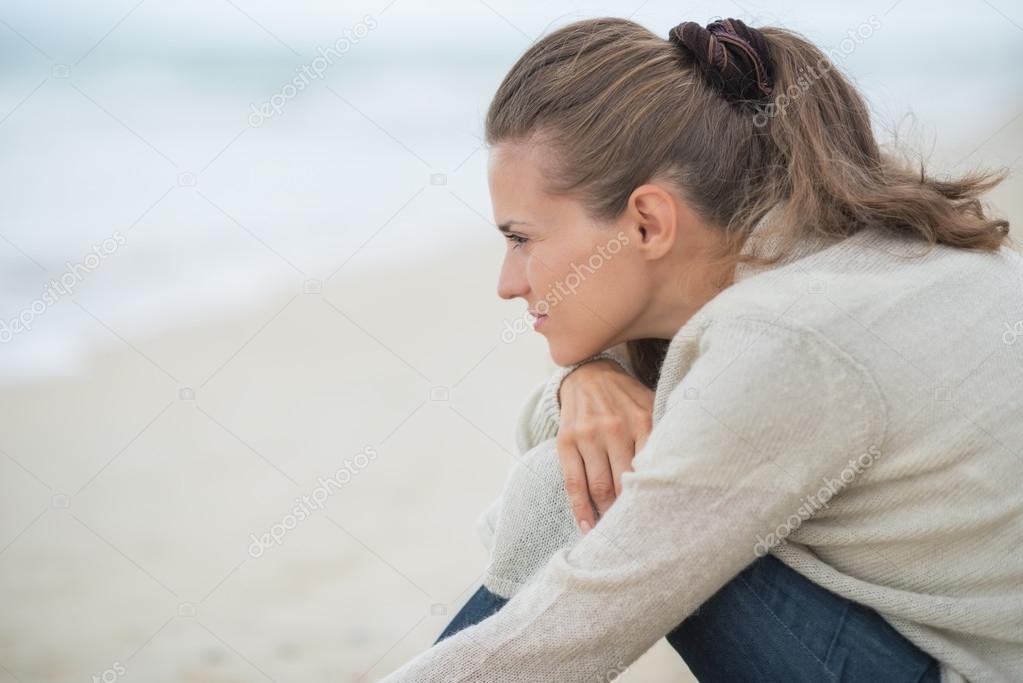 Woman on beach looking into distance