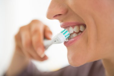 Woman brushing teeth clipart