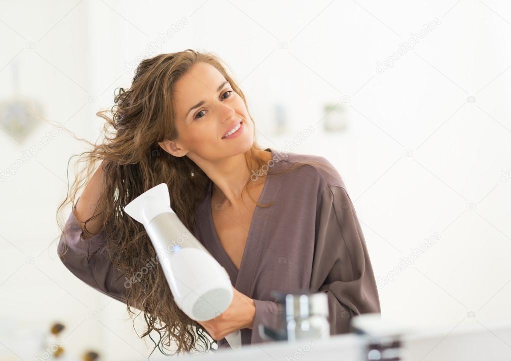 Woman blow drying hair