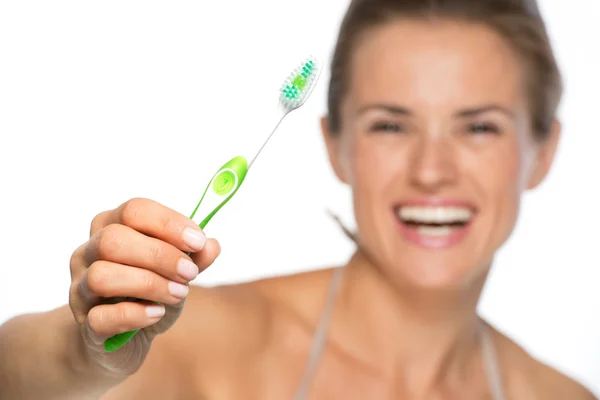 Woman showing toothbrush — Stock Photo, Image