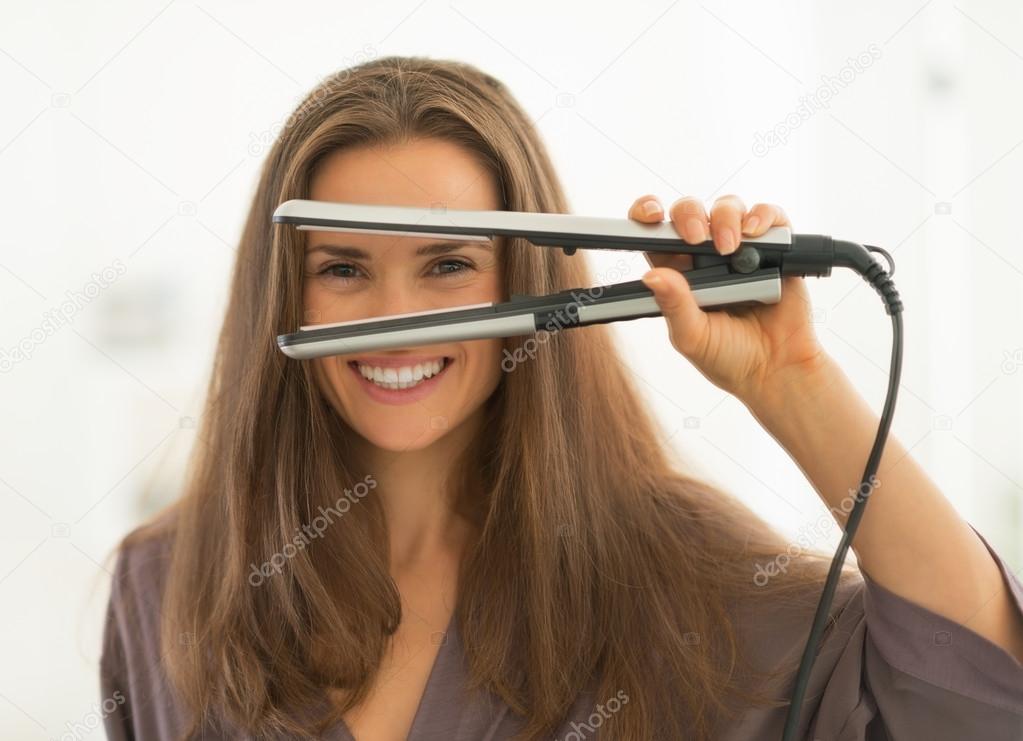 Woman looking through hair straightener