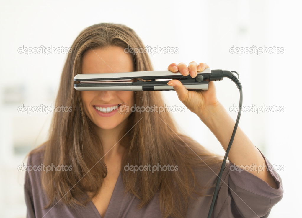 Woman looking through hair straightener