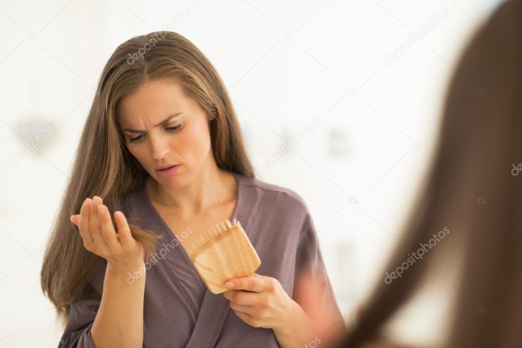 Woman looking on hair comb