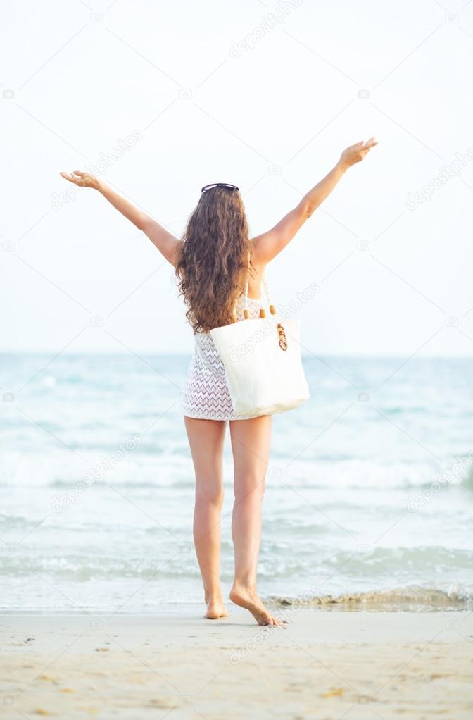 Woman on beach rejoicing