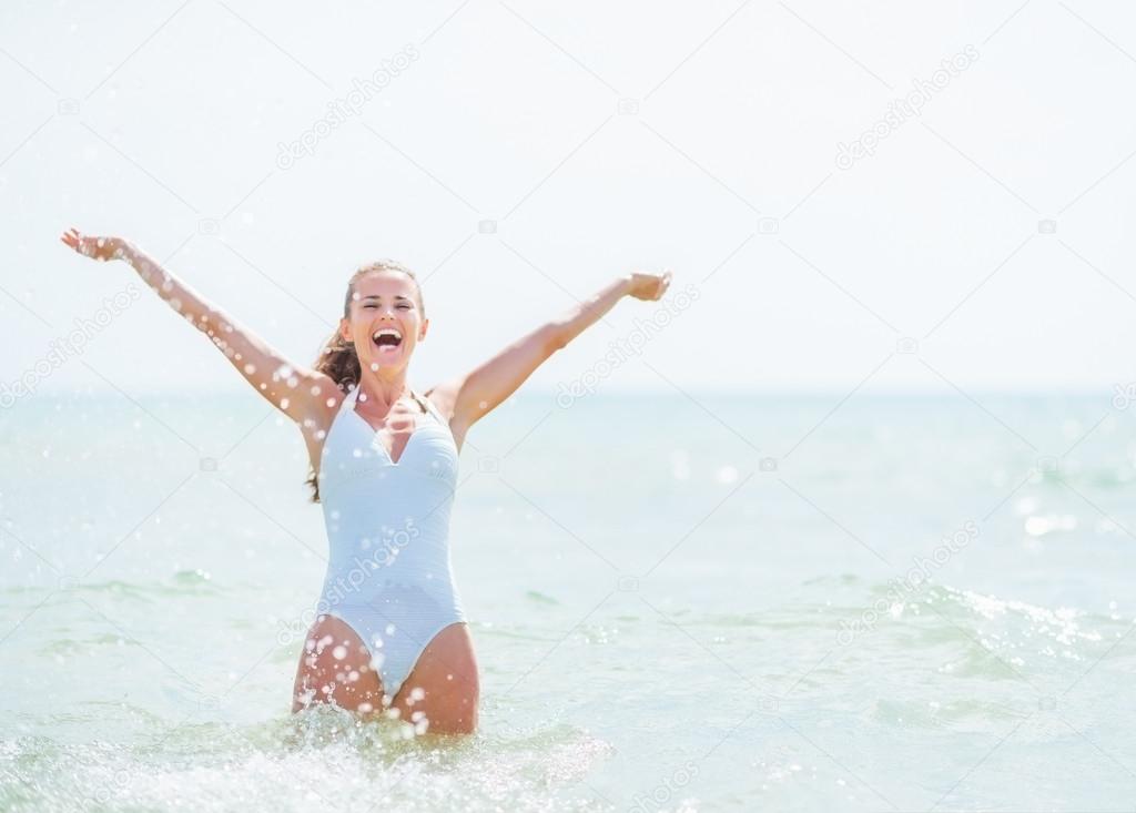 Woman in swimsuit rejoicing