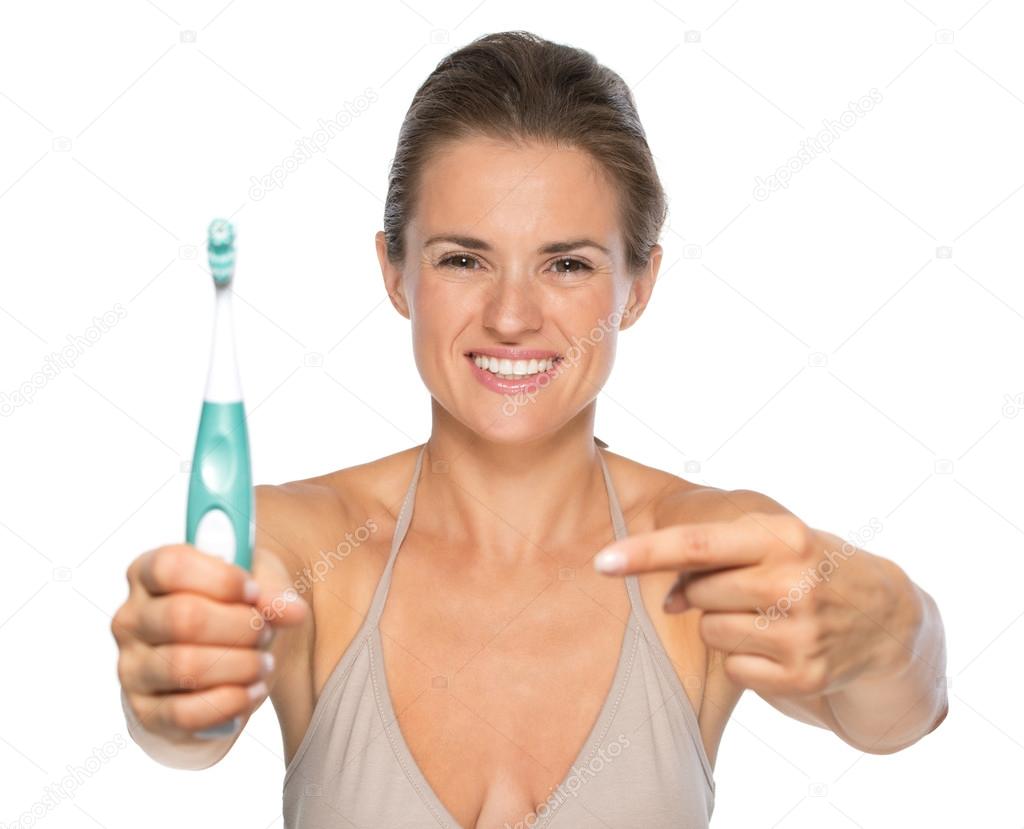 Woman pointing on toothbrush