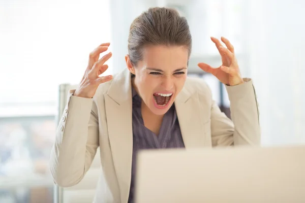 Stressed businesswoman with laptop — Stock Photo, Image