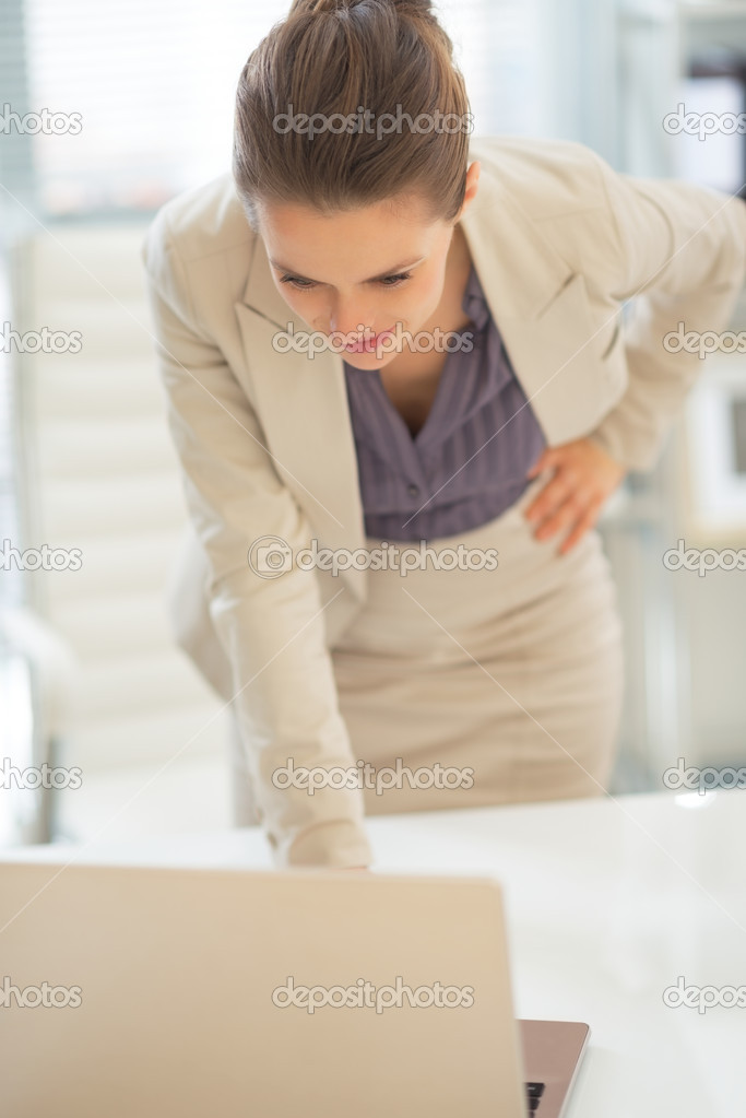Businesswoman looking on laptop