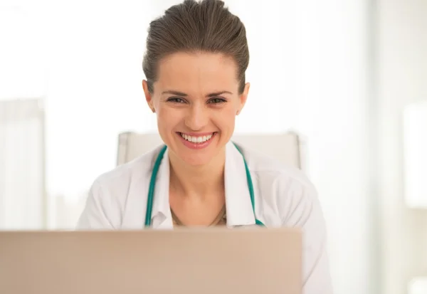 Médico sonriente usando laptop — Foto de Stock