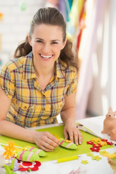 Happy woman making decorative eggs — Stock Photo, Image