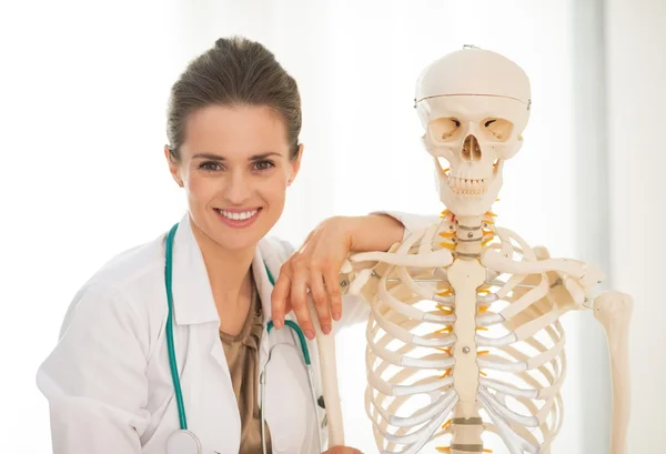 Doctor woman near skeleton model — Stock Image Doctor woman near skeleton model Royalty Free Stock Photos