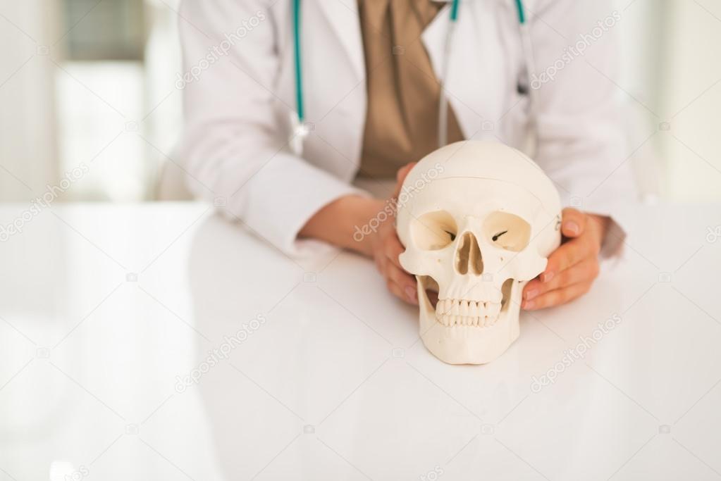 Doctor holding human skull