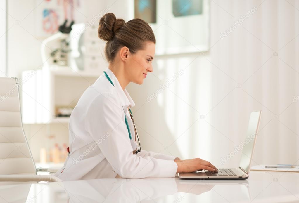 Medical doctor working on laptop in office