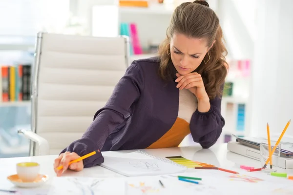 Thoughtful fashion designer working in office — Stock Photo, Image