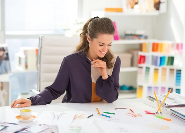 Happy fashion designer working in office — Stock Photo, Image