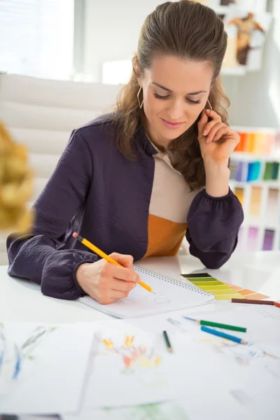 Fashion designer making sketches in office — Stock Photo, Image