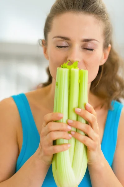 Young woman smelling fresh celery — Stock Photo, Image