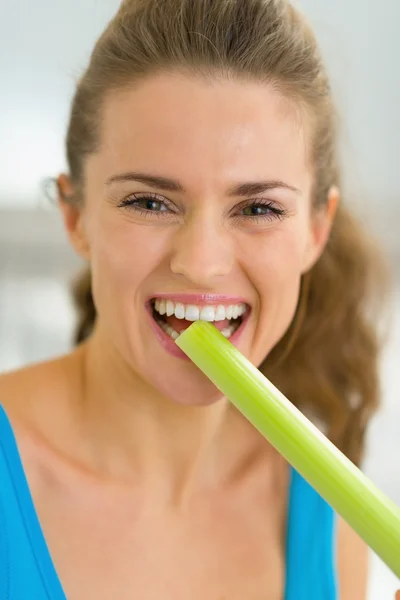 Woman tasting fresh celery — Stock Photo, Image