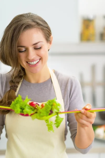 Huisvrouw maken salade in keuken — Stockfoto