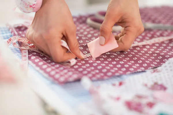 Seamstress making marks on fabric — Stock Photo, Image