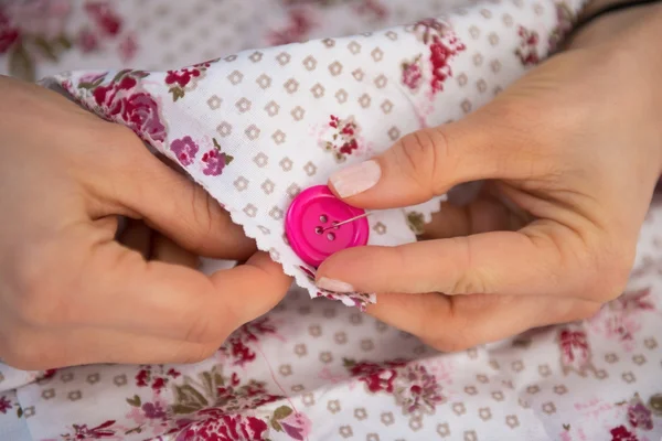 Closeup on seamstress sewing button — Stock Photo, Image