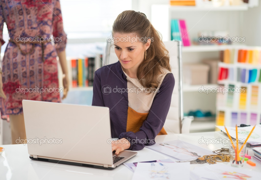 Fashion designer working on laptop in office