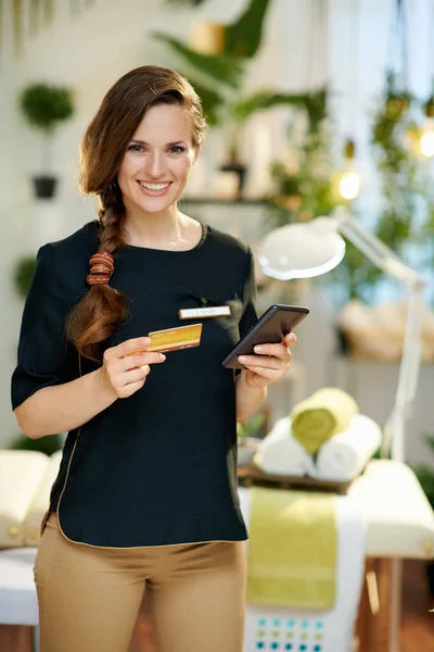 Smiling Middle Aged Woman Employee Smartphone Credit Card Buying Internet — Stock Fotó