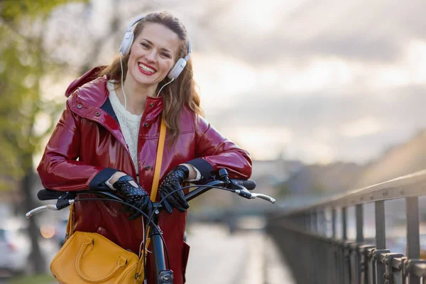 Portrait Smiling Stylish Female Red Rain Coat Bicycle Listening Music — Fotografia de Stock