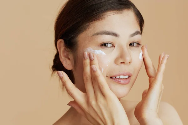 Portrait Modern Asian Female Facial Cream Face Isolated Beige Background — Stok fotoğraf