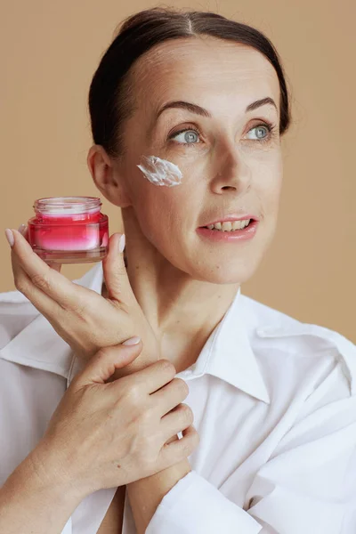 Modern Woman Facial Cream Jar White Shirt Isolated Beige Background — Stockfoto
