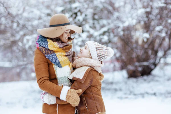 Happy Elegant Mother Daughter Hats Sheepskin Coats Mittens Hugging City - Stock-foto