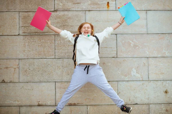 Cheerful Modern Pupil White Sweatshirt Workbook Jumping Wall Outdoors City — Stock Photo, Image