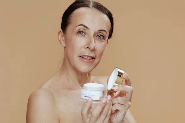 Portrait Modern Middle Aged Woman Facial Cream Jar Isolated Beige — 图库照片
