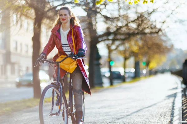 Stylish Female Red Rain Coat City Street Riding Bicycle — Fotografia de Stock