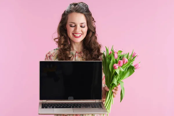 Happy Elegant Woman Floral Dress Tulips Bouquet Showing Laptop Blank — ストック写真