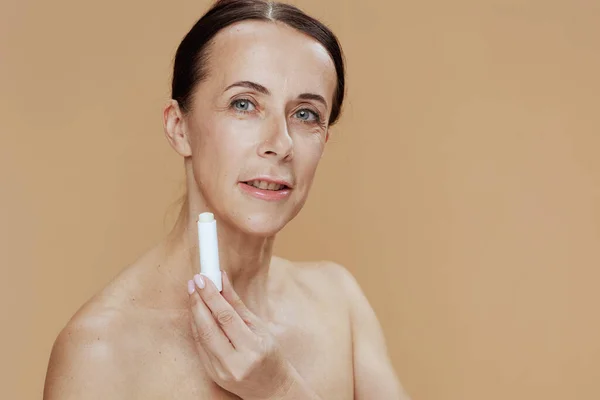 Modern Woman Hygienic Lipstick Beige Background — Stock fotografie